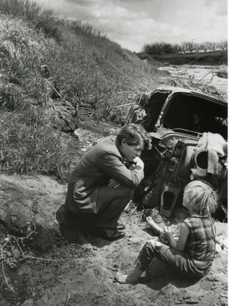 Attorney General Robert F. Kennedy talks with a child during his travels.