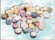Photograph of an assortment of multicolored pills.