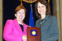 Acting Assistant Attorney General Sharis Pozen presents a 2011 Assistant Attorney General Award to Janet Ficco.