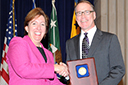 Acting Assistant Attorney General Sharis Pozen presents the 2011 Roberts Award to Jim Tierney.