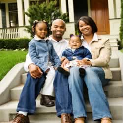 photograph of an African American family in front of a house