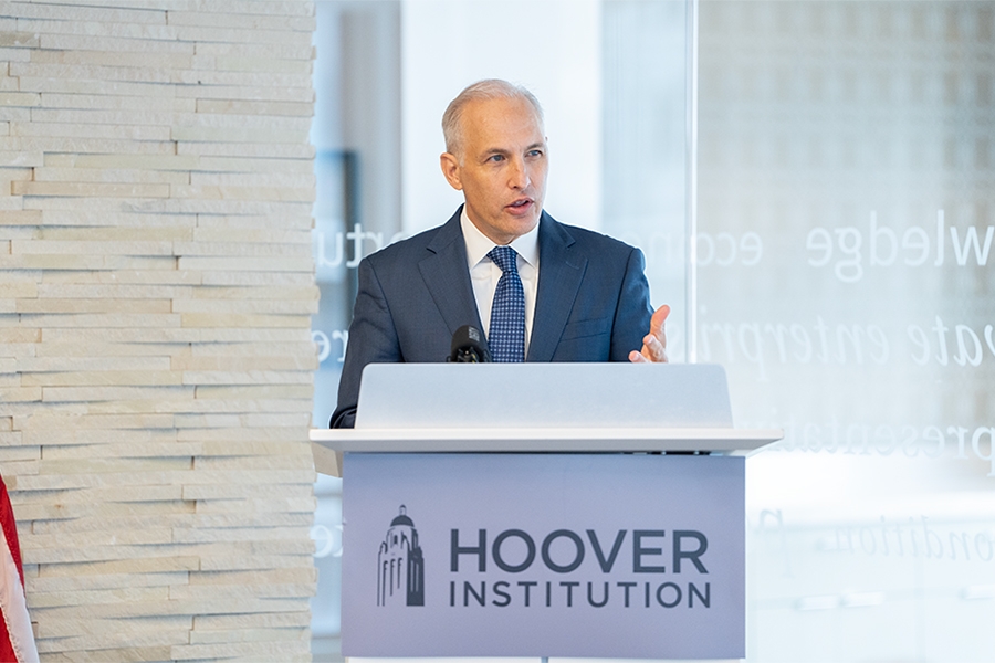 Assistant Attorney General Matthew G. Olsen stands at a podium at the Hoover Institution in Washington, D.C. delivering remarks.