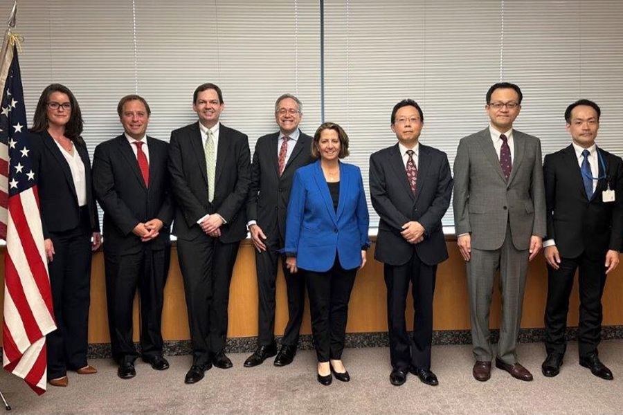 Deputy Attorney General Lisa O. Monaco stands with U.S. officials in the American Embassy in Tokyo, Japan.