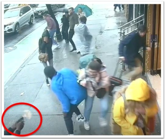 Photo of the defendant shooting the victim on a busy sidewalk