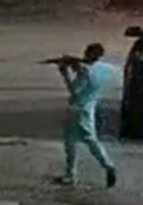 Image of Derrick Smith Jr. aiming a rifle at a passing vehicle in a residential neighborhood once outside of the store.