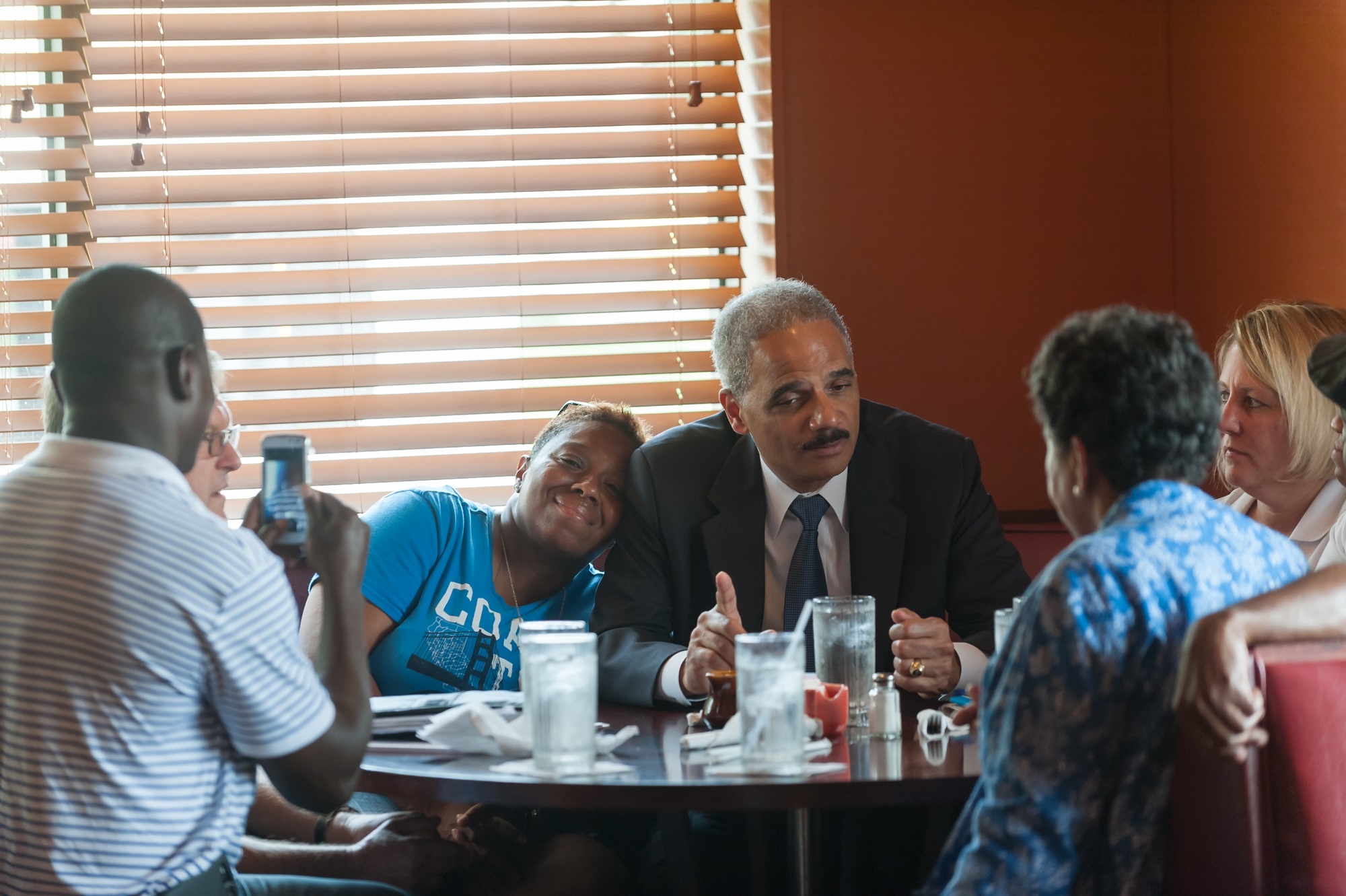 Attorney General Eric Holder speaks with community members at Drake's Place restaurant.