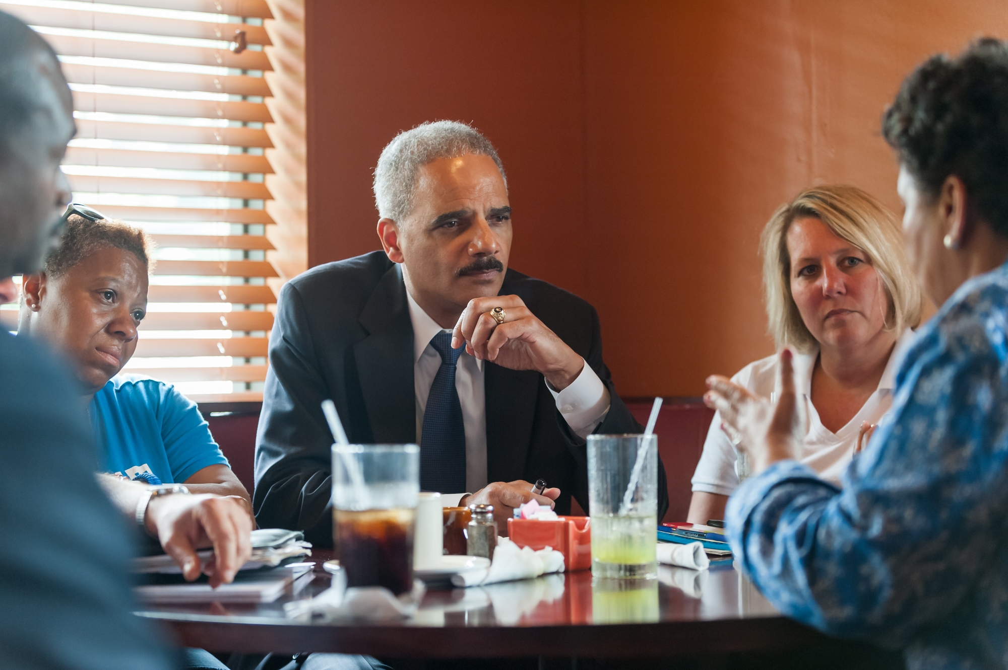 Attorney General Eric Holder speaks with community members at Drake's Place restaurant.