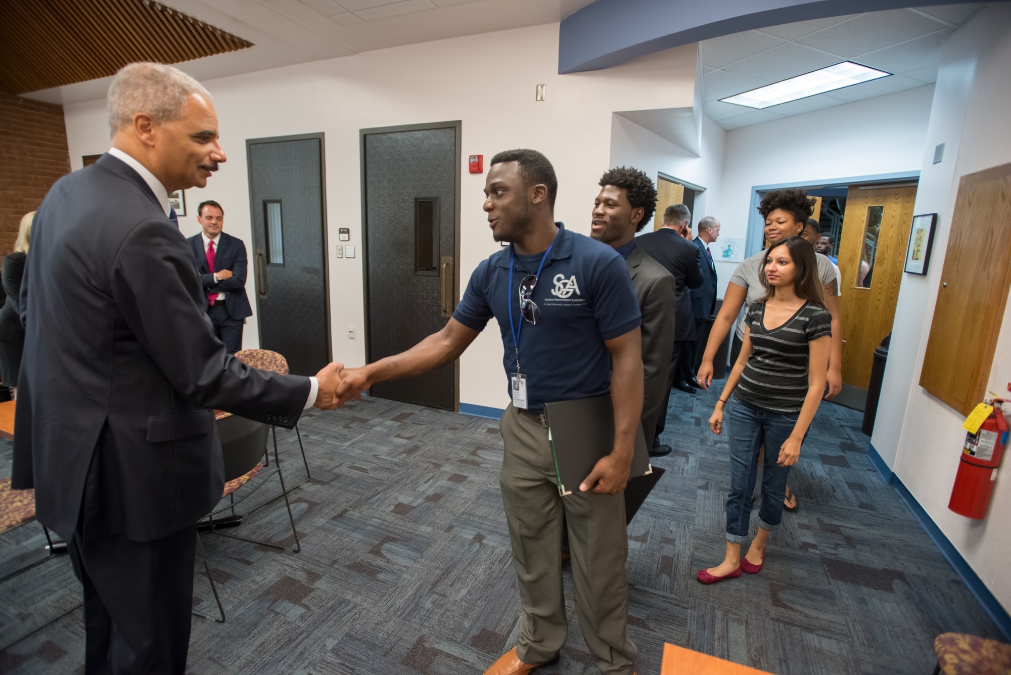 Attorney General Eric Holder greets students at the Florissant Valley Community College in north St. Louis.