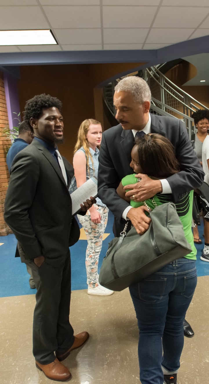 Attorney General Eric Holder hugs a student at the Florissant Valley Community College in north St. Louis.