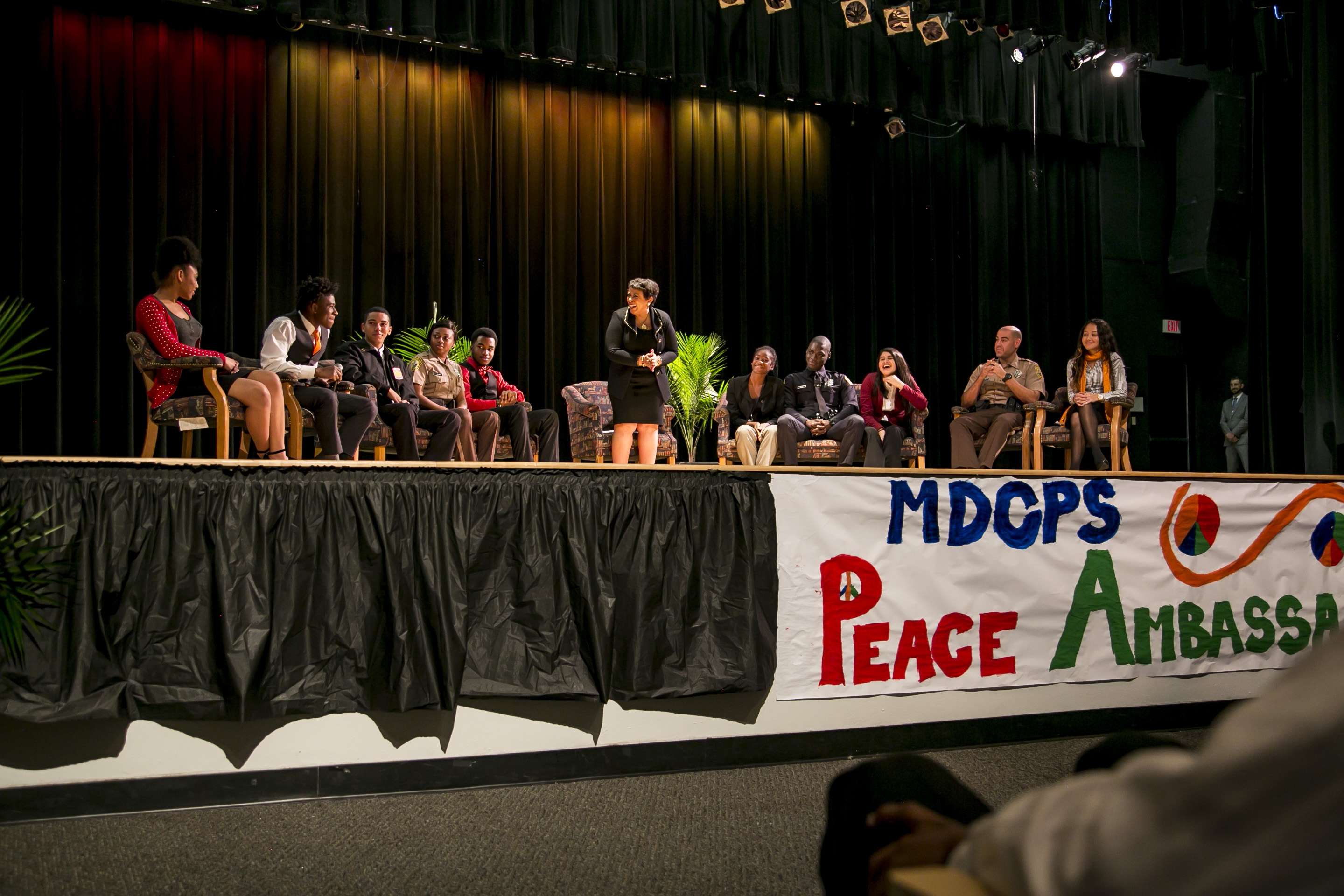 Attorney General Lynch, Student Peace Ambassadors, and officers discuss police-community relations at a youth down hall at Miami
