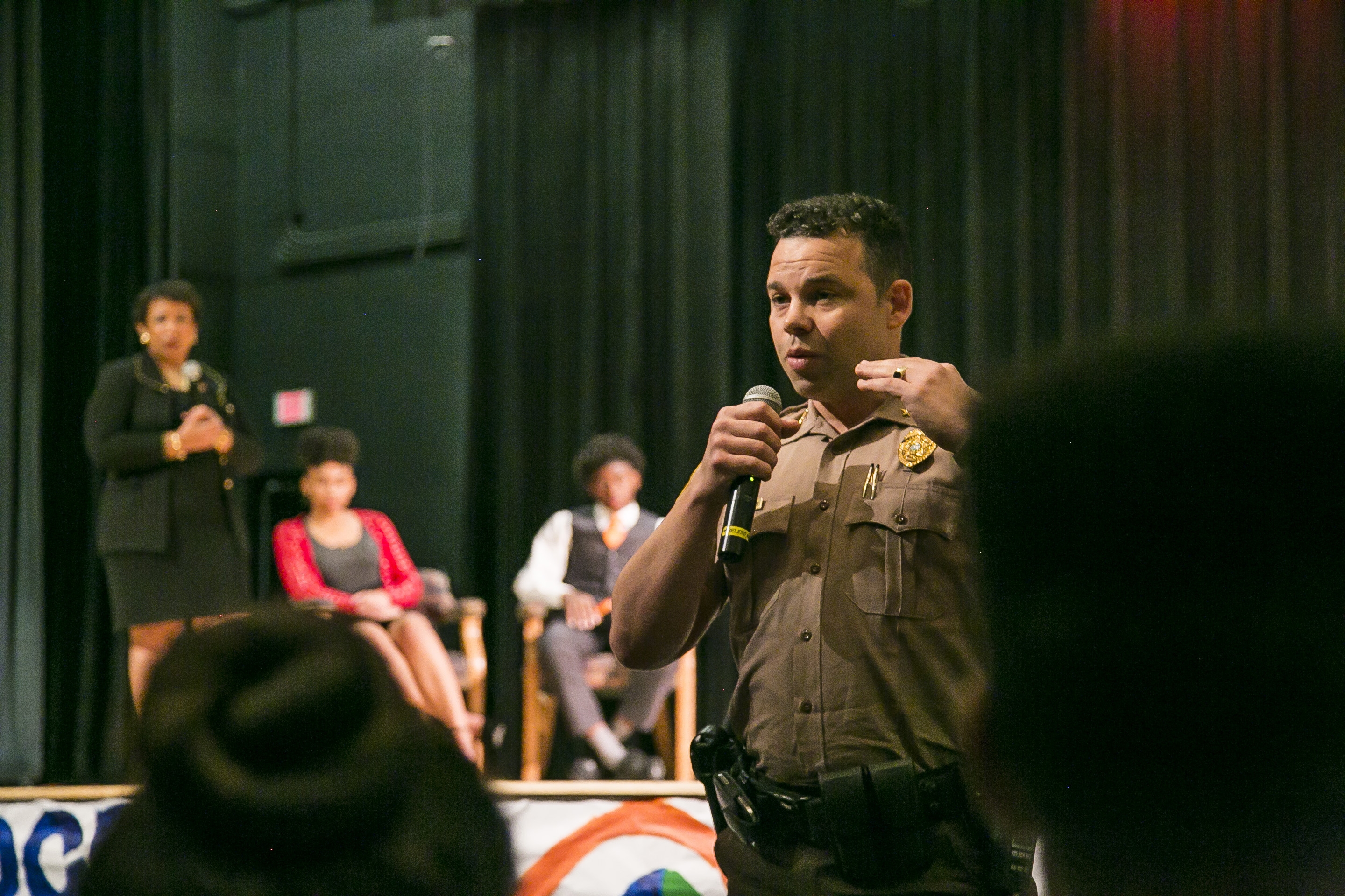 Attorney General Lynch, Student Peace Ambassadors, and officers discuss police-community relations at a youth down hall at Miami