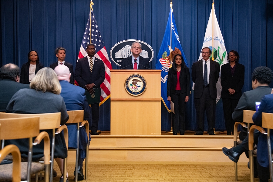 Attorney General Merrick B. Garland delivers remarks on the podium. To the left are: Assistant Attorney General Kristen Clarke of the Civil Rights Division, Assistant Attorney General Todd Kim of the Environmental and Natural Resources Division, and EPA administrator Michael S. Regan. To the right are: Associate Attorney General Vanita Gupta and ENRD's Acting Director Cynthia Ferguson
