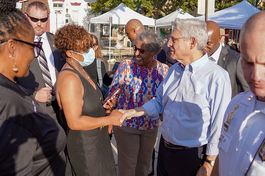 Attorney General Merrick B. Garland shakes hands with law enforcement and community members on National Night Out in Baltimore, MD.