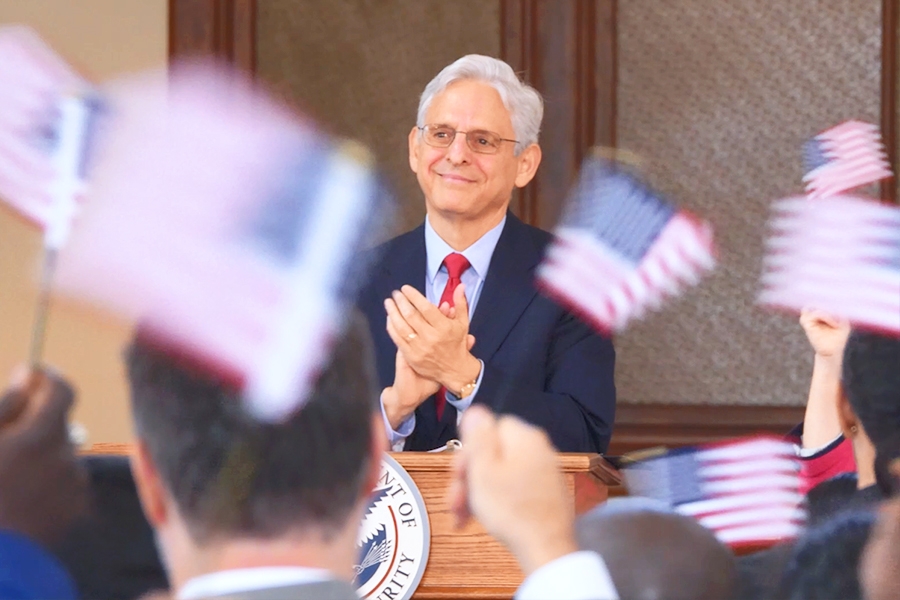 Attorney General Merrick B. Garland delivers a speech to the crowd in the Great Hall of Ellis Island.