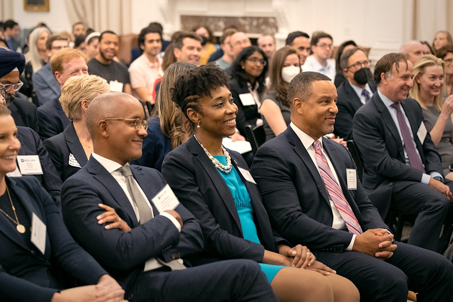 An audience composed of attorneys, officials, and other experts smile at the Deputy Attorney General’s response to a question