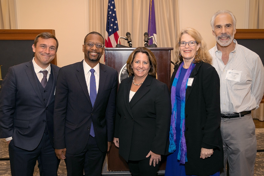Deputy Attorney General Lisa O. Monaco stands with Dean McKenzie of NYU’s School of Law as well as other NYU Law professors for a photo