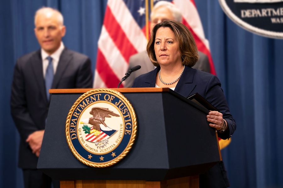 Deputy Attorney General Lisa O. Monaco delivers remarks at a podium bearing the Department of Justice seal.