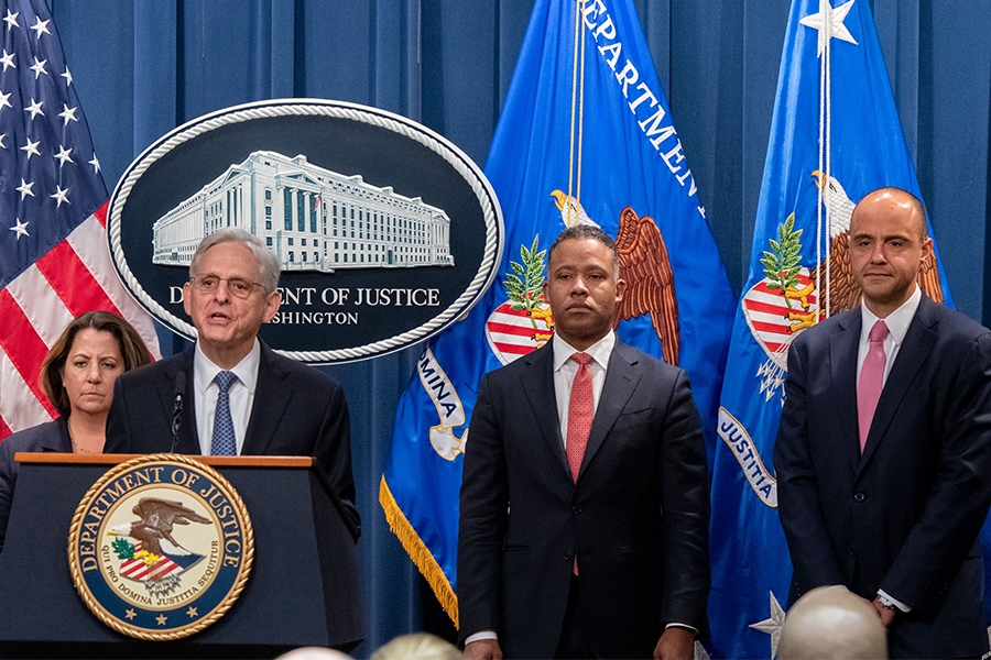 Attorney General Merrick B. Garland delivers remarks from a podium bearing the Department of Justice seal