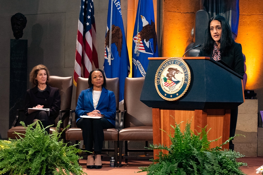 Associate Attorney General Vanita Gupta delivers remarks from a podium in the Great Hall at the Department of Justice.