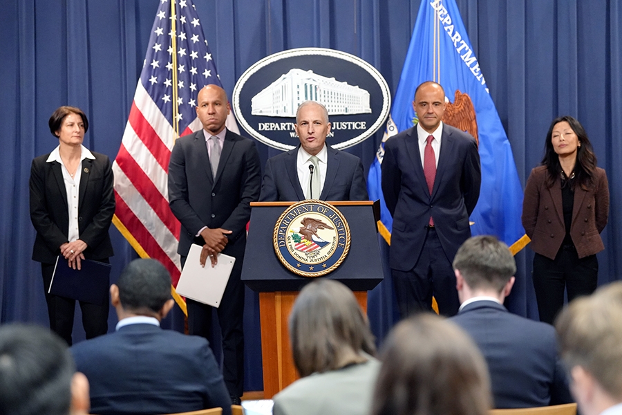 Assistant Attorney General for National Security Matthew G. Olsen delivers remarks from a podium bearing the Department of Justice seal.