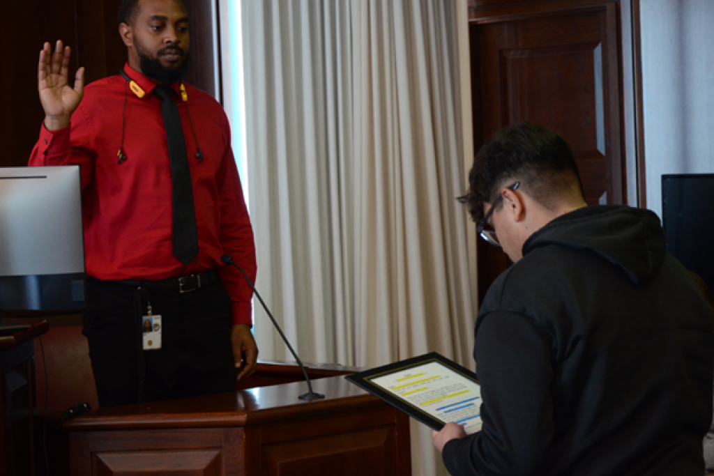 Community Outreach Specialist John Hampton gets sworn in by a Bowman Ashe/Doolin K-8 Academy student prior to testifying during a recent mock trial. Community Outreach Specialist John Hampton gets sworn in by a Bowman Ashe/Doolin K-8 Academy student prior to testifying during a recent mock trial.