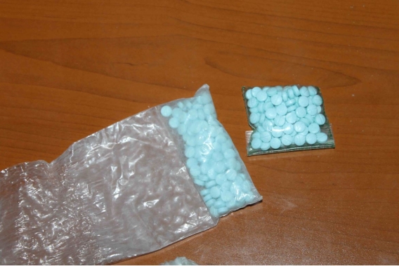 a bag of blue pills on a table 