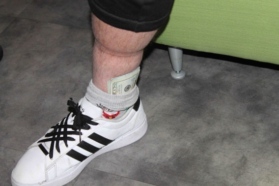 a ma sock and shoe. There is cash sticking out of the sock 