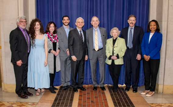 Attorney General Merrick B. Garland (fifth from the left) and Assistant Attorney General for Civil Rights Kristen Clarke (far right) stand with the families who were honored at the 30th Annual Federal Inter-Agency Holocaust Remembrance Program.