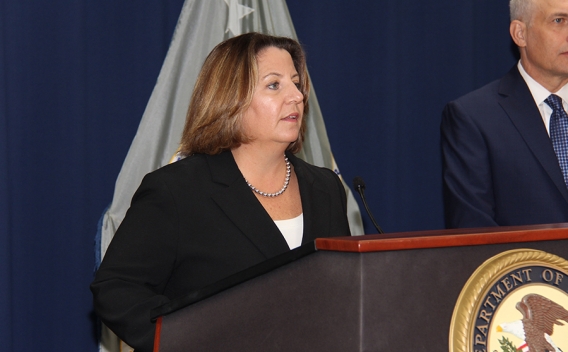 Deputy Attorney General Lisa O. Monaco speaks at the podium at the U.S. Attorney’s Office for the Eastern District of New York