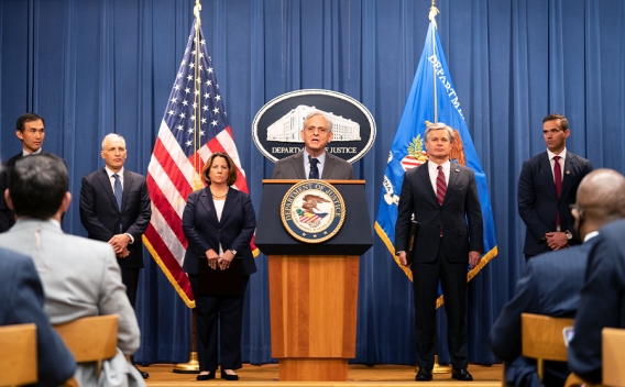 Attorney General Merrick B. Garland delivers remarks at a podium bearing the Department of Justice seal.