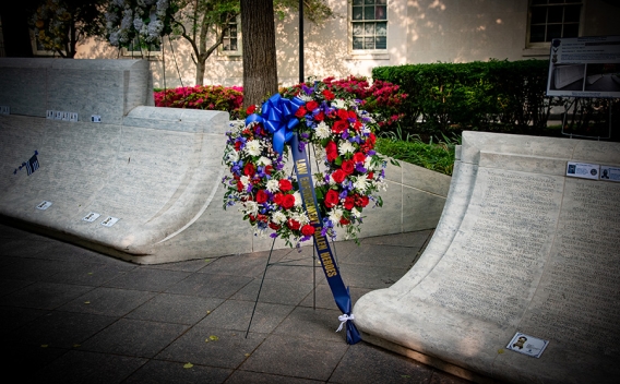 A wreath rests on a stand at the National Law Enforcement Memorial with a ribbon that reads, “Law Enforcement Fallen Heroes.”