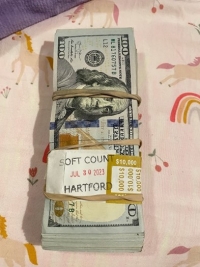Image of a bundle of cash wrapped in a paper band stamped with the word "Hartford"