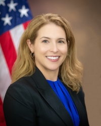 Jill E. Steinberg Photo of Jill Steinberg in front of American flag