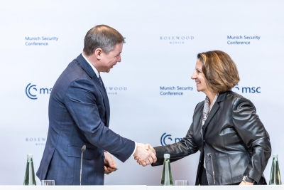 Deputy AG Monaco and Estonian Secretary General Saar shake hands after signing an international sharing agreement in support of Ukraine at the 2024 Munich Security Conference.