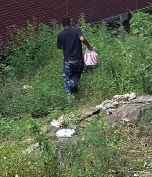 Photo of the defendant exiting the area of the Daycare through bushes