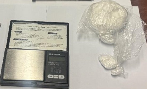 A photograph of the scale and bags of cocaine 