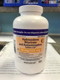 A bottle of Schedule II hydrocodone medication whose contents will be put through a pill counter as part of an inventory of a pharmacy's controlled substance medications taken during the June 2018 National Health Care Fraud and Opioid Take Down