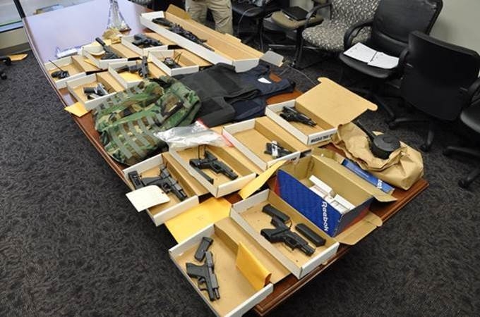 Firearms and vests seized during the execution of a DEA Tactical Diversion Squad search warrant.