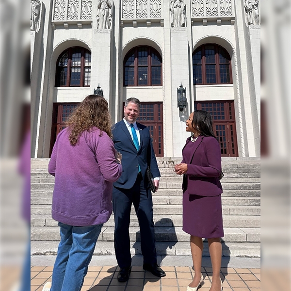 Assistant Attorney General Clarke with U.S. Attorney Ross speaking to a teacher at Little Rock Central High School.