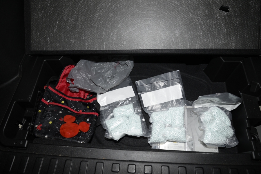 Seized counterfeit oxycodone containing fentanyl stored in clear bags.