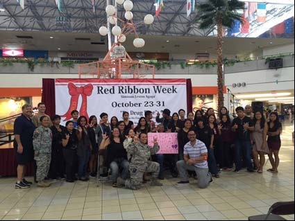 Members of the Red Ribbon Committee with students of the Guam Community College’s sign language class who performed several numbers at the Red Ribbon Campaign Outreach at the Micronesia Mall in Guam