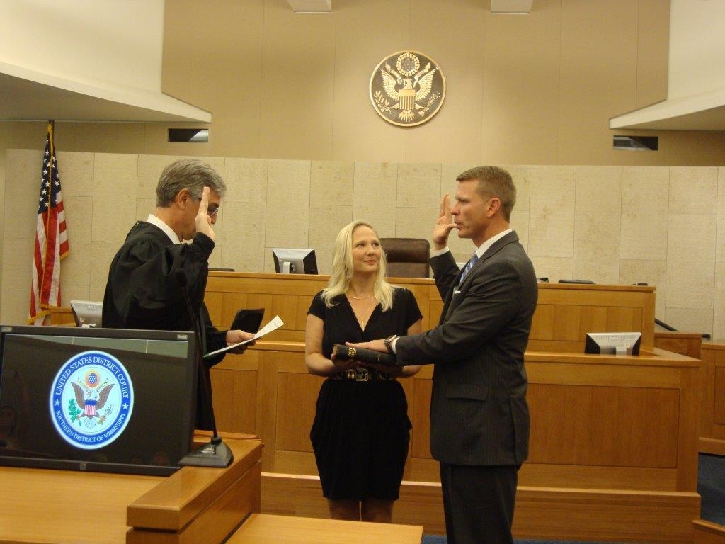 Mike Hurst is sworn in as the United States Attorney for the Southern District of Mississippi by U.S. District Judge Daniel P. Jordan in Jackson, Mississippi.  Also pictured is his wife, Celeste.