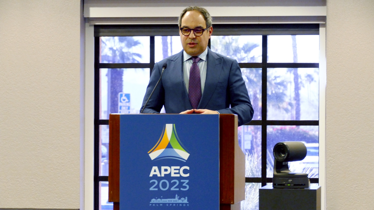  Assistant Attorney General Jonathan Kanter of the Antitrust Division stands at a podium, delivering remarks at APEC conference.