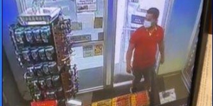Man walking into a convenience store/gas station 