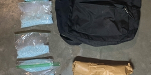 a black backpack with baggies of drugs 