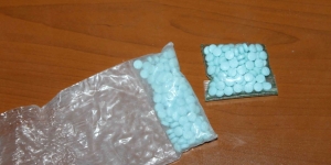 a bag of blue pills on a table 