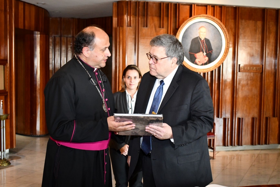 Attorney General Barr receiving a gift from Monsignor Salvador Martinez Avila, the Rector of the Sanctuary of the Basilica.